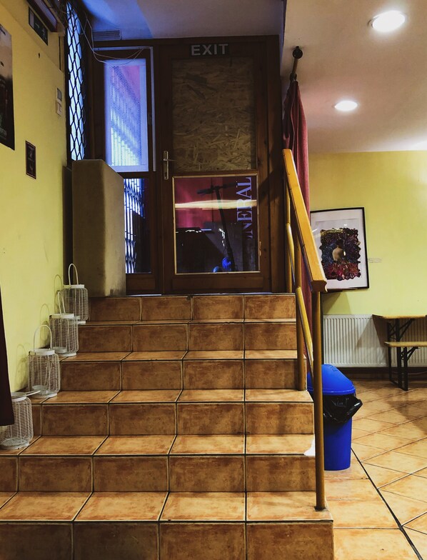 A staircase leading to an exit with a sign above it.