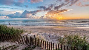 A beach with a wooden fence and sand dunes. - Private Beach Access- Direct Oceanfront (Melbourne Beach)