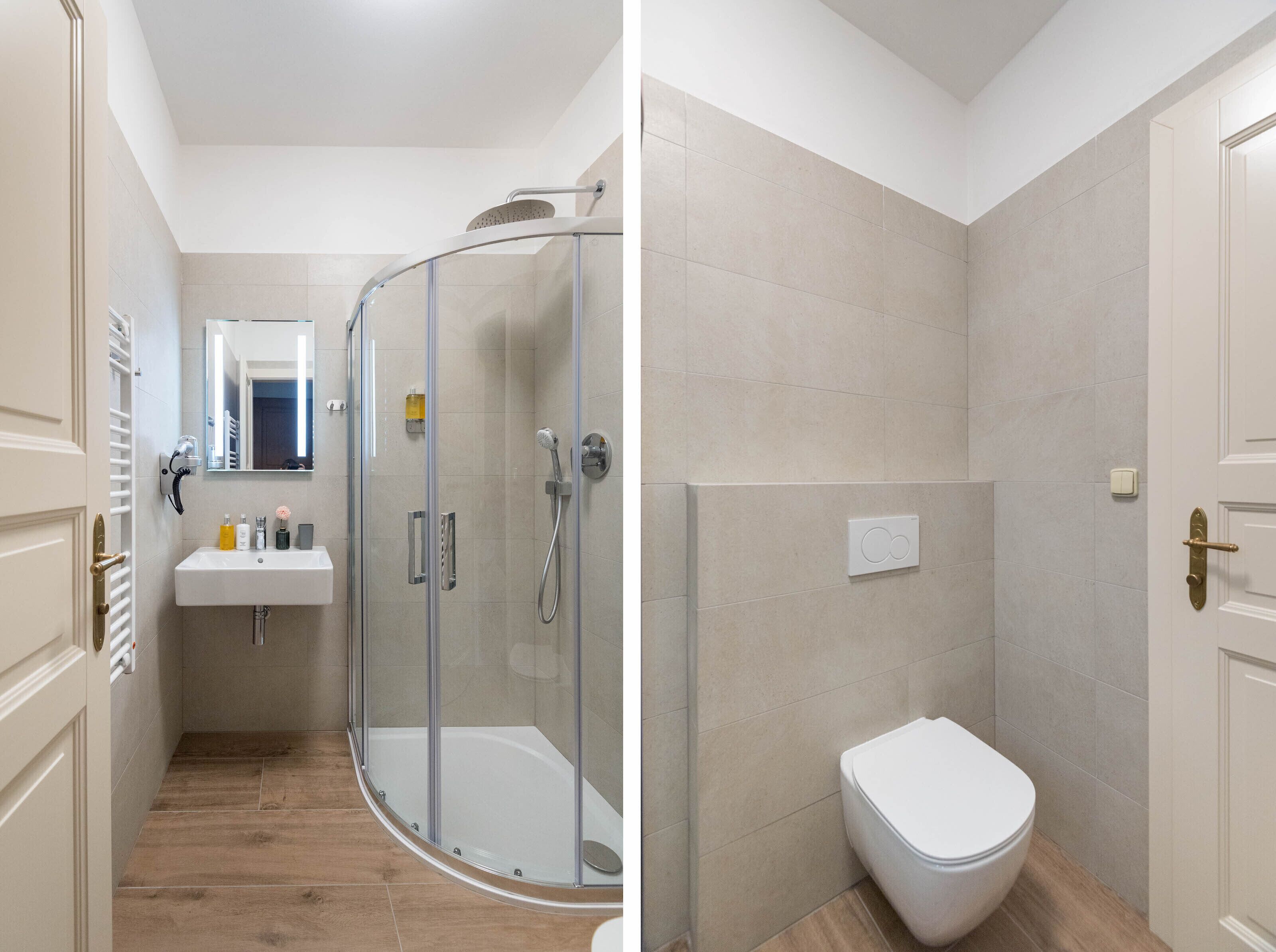 A bathroom with a glass-enclosed shower, a white sink, and a toilet.