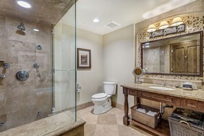 A bathroom with a glass-enclosed shower, a toilet, a vanity with a mirror, and a sink. - The Aspen Mountain Residences Luxury Studio King Room Mountainside (Aspen)