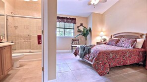 A bathroom with a shower, toilet, and vanity.