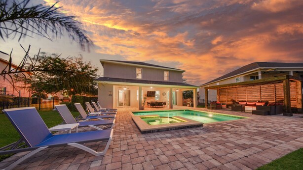 A house with a swimming pool, lounge chairs, and a patio area. - Charming Estate with Themed Bedrooms at Encore (Kissimmee)