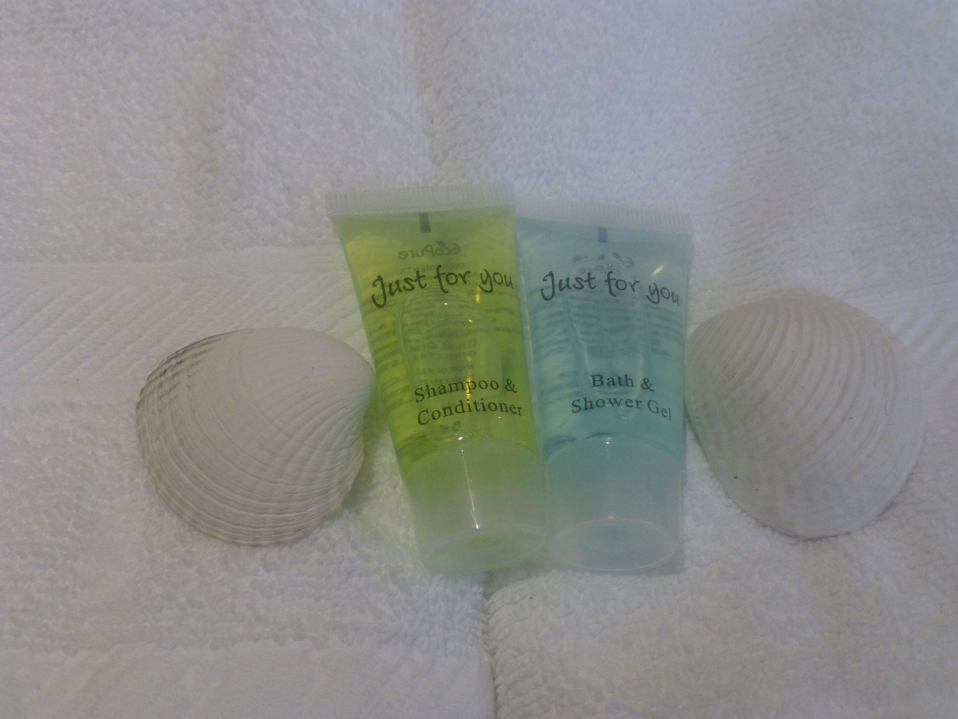 Three toiletry bags labeled 'Just for you' with 'Shampoo & Conditioner' and 'Bath & Shower Gel'.