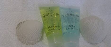 Three toiletry bags labeled 'Just for you' with 'Shampoo & Conditioner' and 'Bath & Shower Gel'.