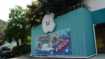 A building with a large mural on its side, featuring a skateboarder and the text "WEEKEND SPORTS".