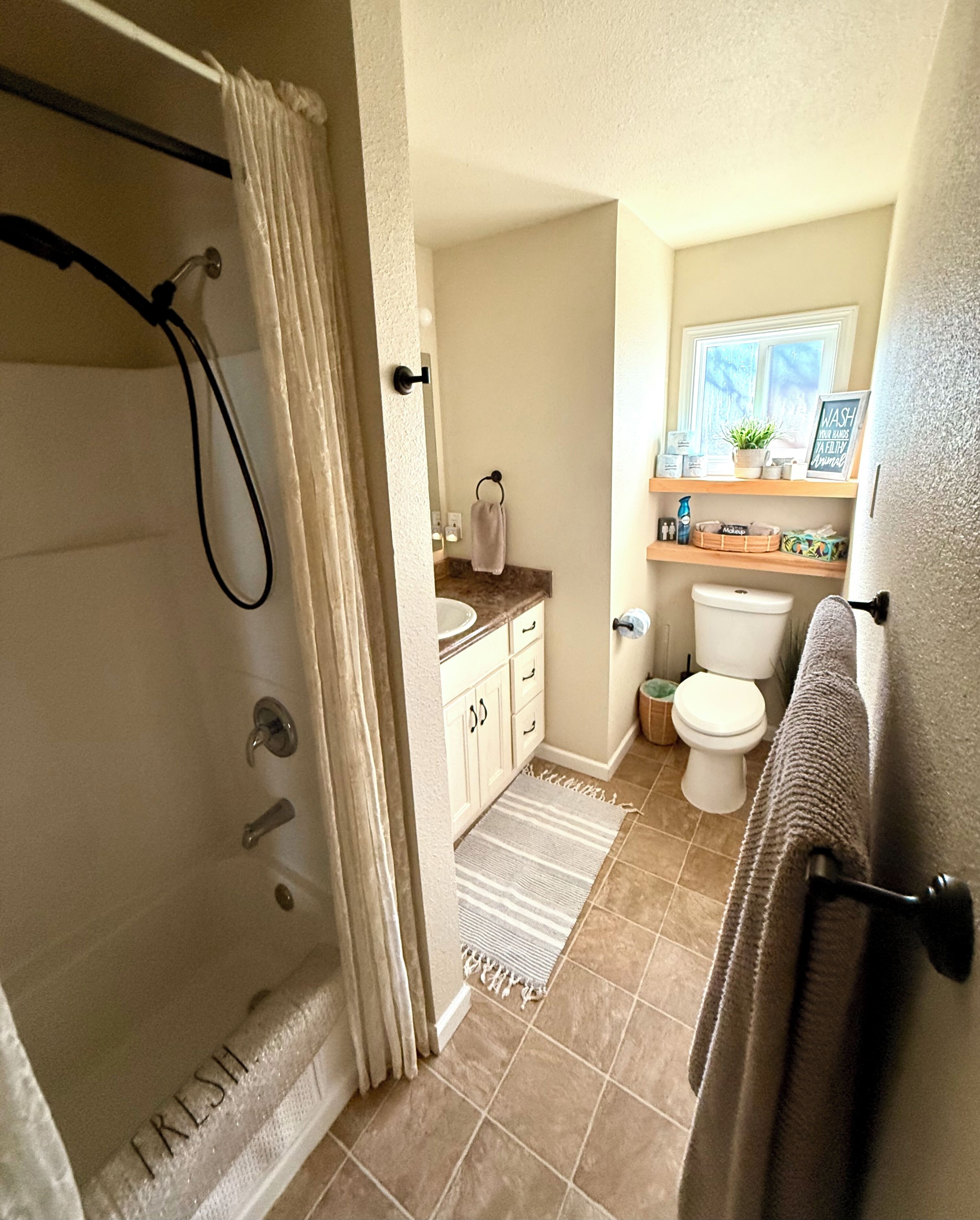 Combined shower/tub, hair dryer, towels, soap