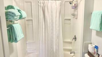 Combined shower/bathtub, hair dryer, towels, soap