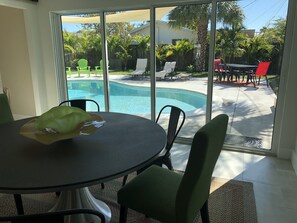 Relax in a serene space with an outdoor area featuring a pool and lawn views.
