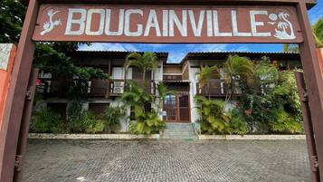 A sign with the name "BOUGAINVILLE" and a logo of a palm tree.