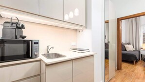 A modern kitchen with a microwave, sink, and a digital scale. - Stylish Apartment | Air Conditioning | Close Center (Warszawa)