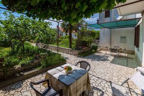 Relax in an outdoor space with a shaded table and comfortable seating.