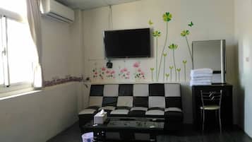 Comfort Quadruple Room (C202) | Living area | Flat-screen TV