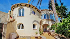 A stucco building with arched windows and a tiled patio area. - May - pretty holiday property with private pool in Benissa (Benissa)