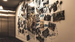 A wall covered with various photographs and text, including 'Chateau de Mermet' and 'Enestrille'.