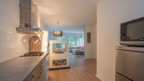 A modern kitchen with a built-in stove, stainless steel appliances, and a wooden island.