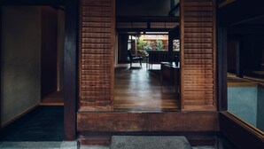 A traditional wooden interior with a view to a garden.