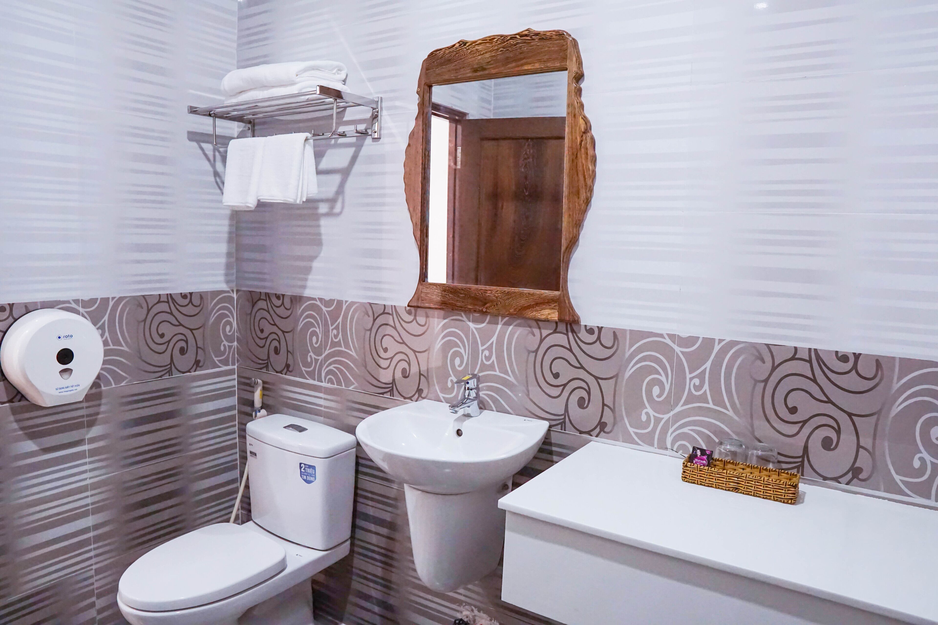 A bathroom with a toilet, sink, and vanity.