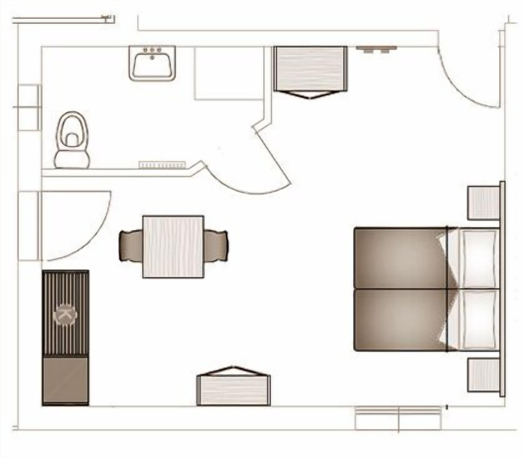 A floor plan of a hotel room with a bed, a desk, a chair, a wardrobe, a bathroom, and a small seating area.