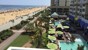 A resort with a pool area, beach access, and a view of the ocean. - Oceanaire - 1BR/1BA - Spectacular Oceanfront View on the Boardwalk (Virginia Beach)