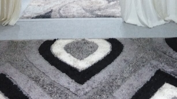 A bedroom with a bed, nightstands, a mirror, and a patterned rug. - Stone Lobby 11 (Markopoulo Mesogaias)