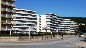 A multi-story hotel with balconies, a restaurant on the ground floor, and a clear view of the street. - ROCAMAURA I A 1-2 (Estartit)
