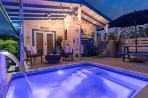 A pool area with a hot tub, seating, and a covered patio. - @ BOQUERON Santorini cozy Cottage, full AC, private heated pool, sleeps 6 (Cabo Rojo)