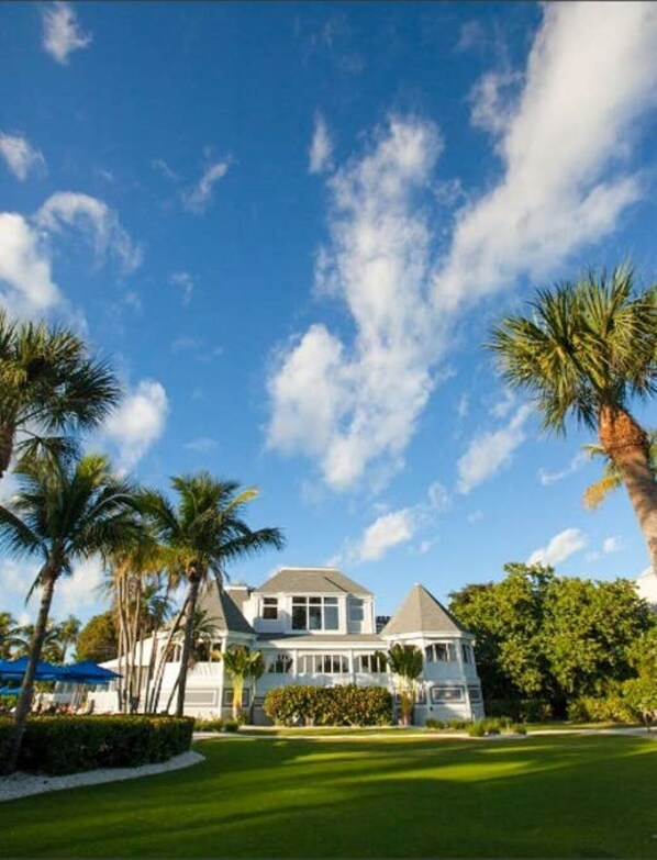Stunning two-story house with a wrap-around porch and beautiful views of the surrounding landscape.
