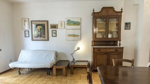 Une pièce comprenant un lit, un bureau, une chaise, une table à manger et un buffet.