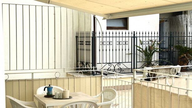 A patio with a table and chairs, a coffee maker, and a metal fence. - N219 - Numana, delightful two-room apartment in the center (Numana)