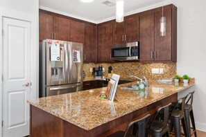 Fridge, microwave, coffee/tea maker, cookware/dishes/utensils