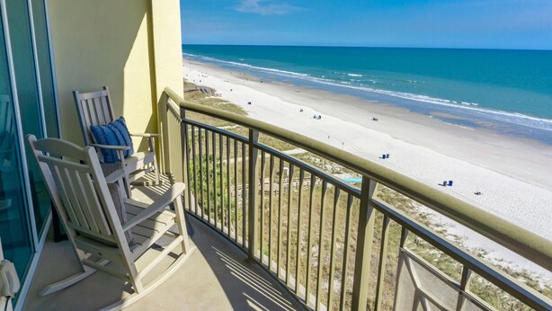 A balcony with a view of a beach. - MVG 909 Oceanfront NEW UPDATES (North Myrtle Beach)