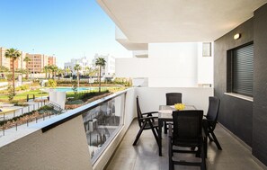 Enjoy a refreshing view of the pool and landscaped area from this balcony.