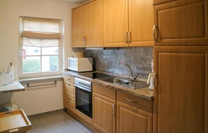 Fridge, stovetop, dishwasher, coffee/tea maker