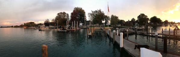 Enjoy waterfront views from the dock, where a small boat is moored and a flag flies high.