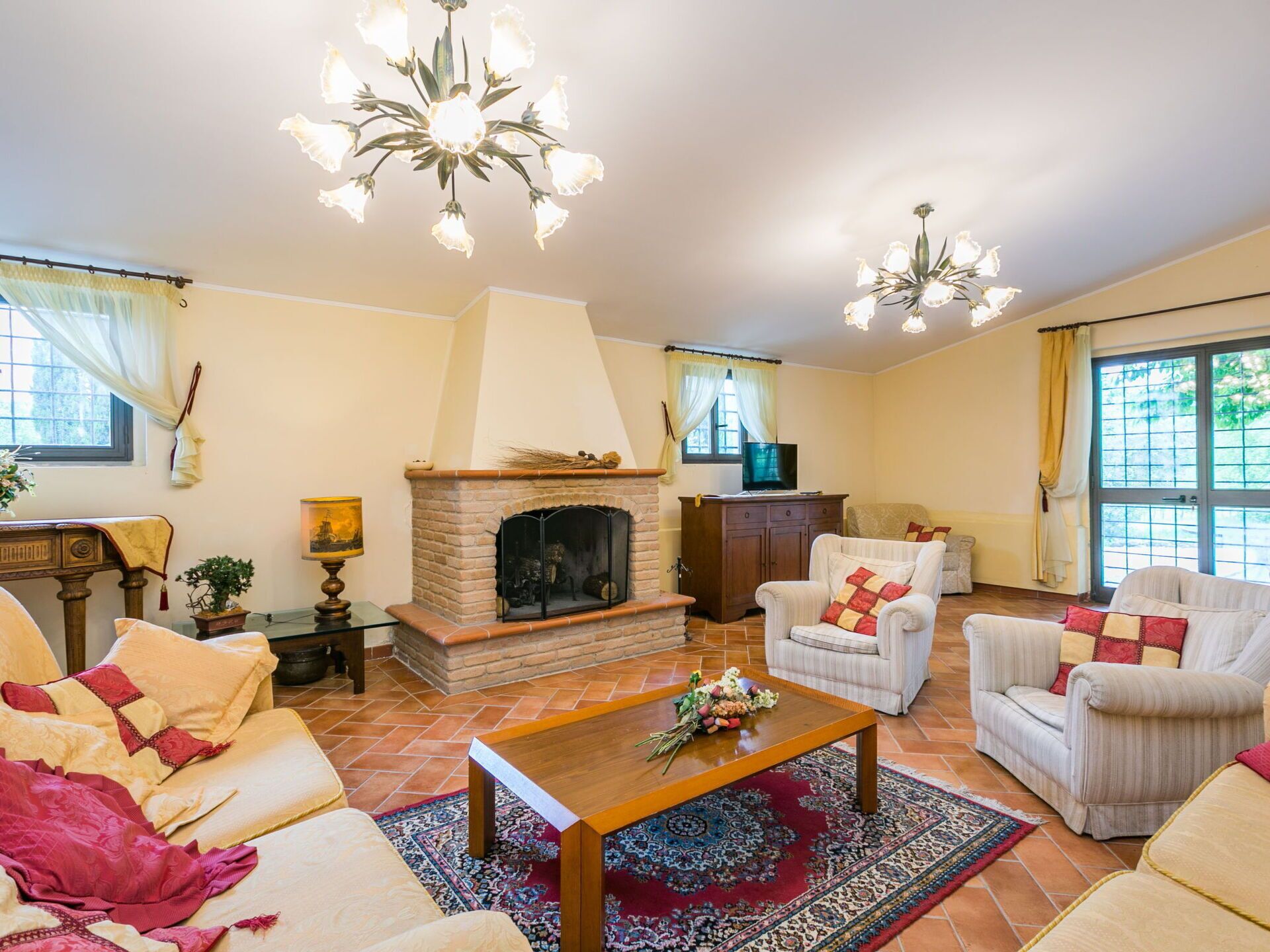 A cozy living room with a fireplace, comfortable seating, and decorative lighting.