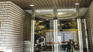 A building with a sign in Japanese characters, a glass entrance, and a brick facade. - Nestle Tokyo Deluxe Akihabara 04 (Tokyo)