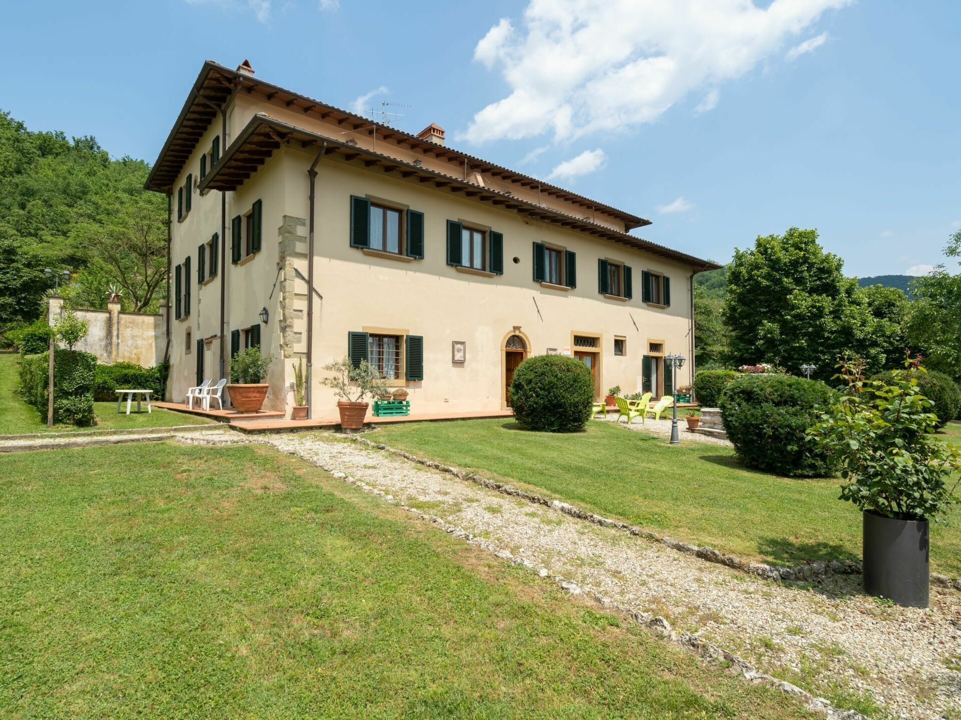 A two-story building with a garden in front.