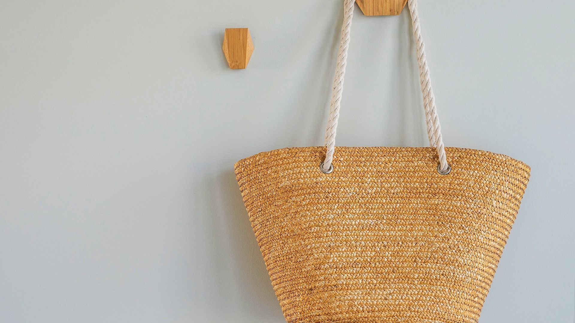 A woven basket hanging on a wall.