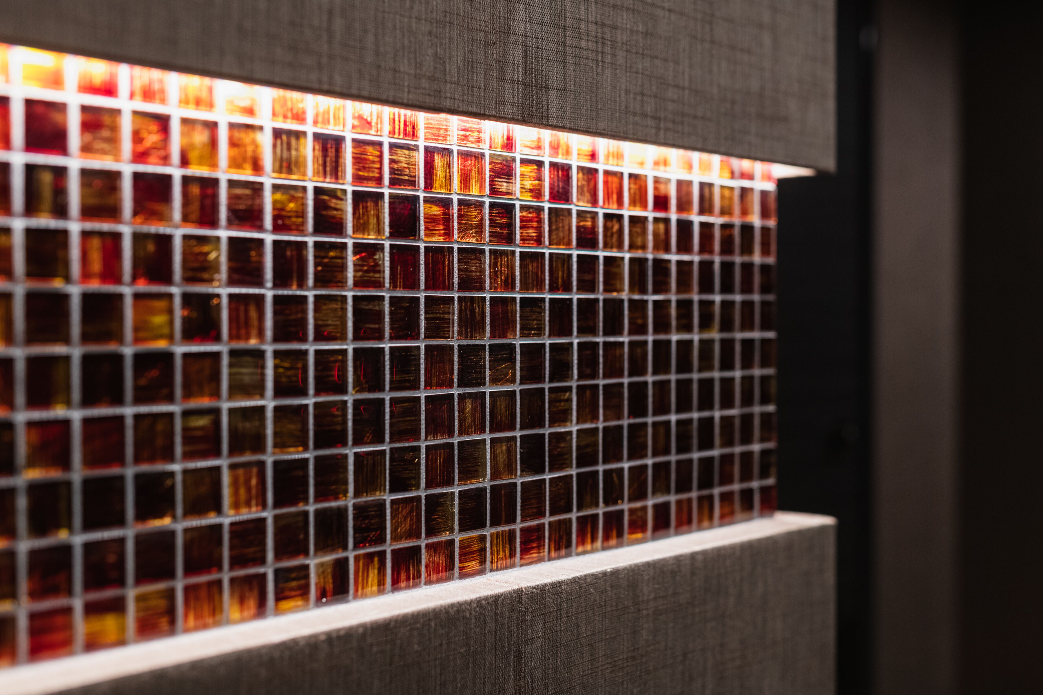 A close-up of a tiled wall with a grid pattern.