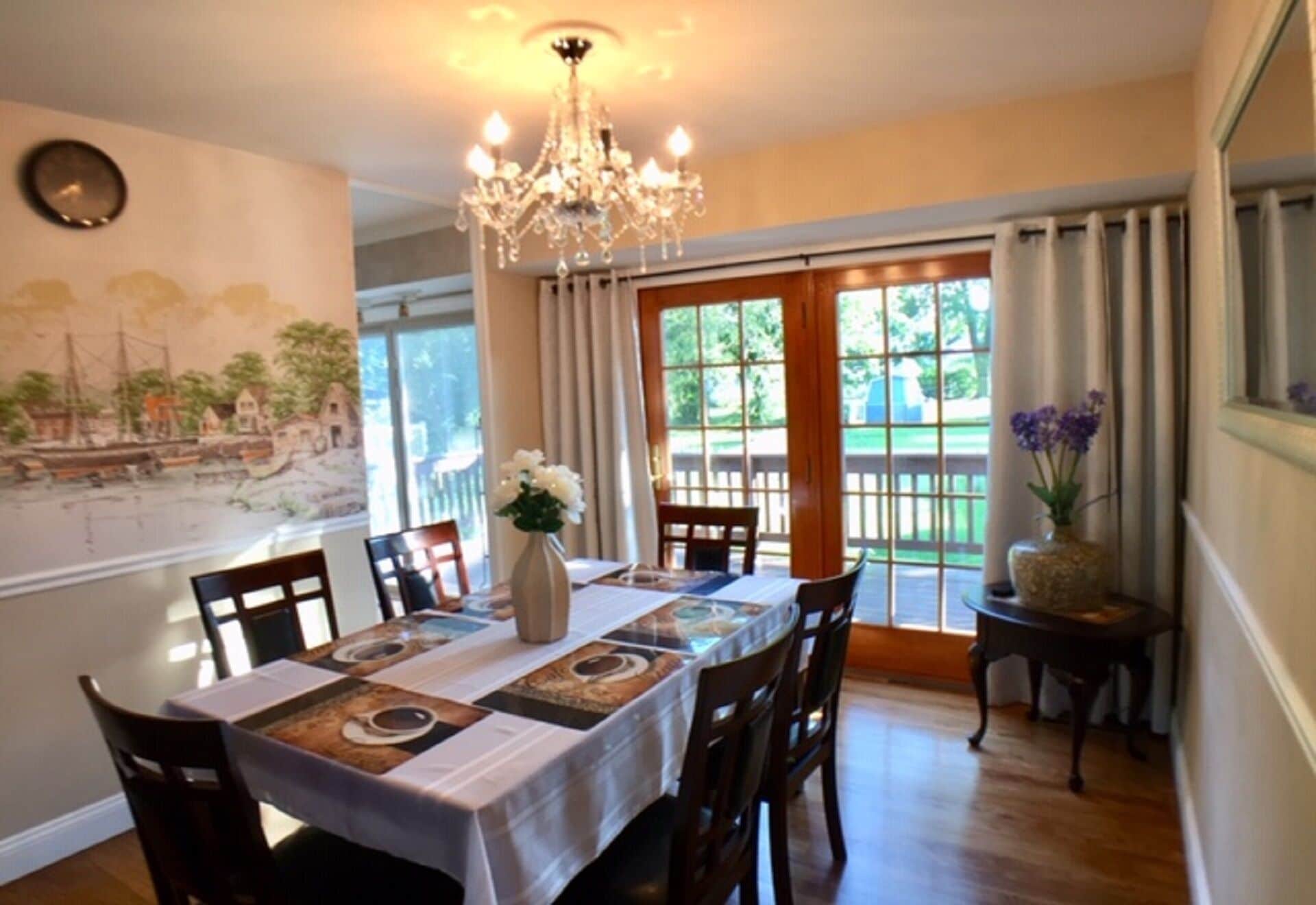 Dining room leads to the wooden deck & a brick patio through French doors.