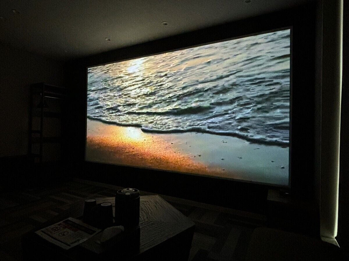 A large flat-screen TV displaying a sunset over the ocean.