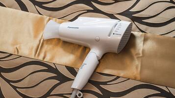 A Panasonic hair dryer on a patterned fabric.