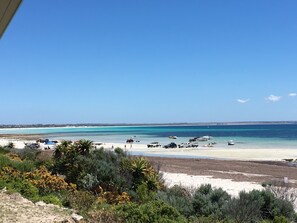 On the beach, sun-loungers