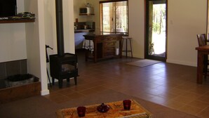 Una sala de estar acogedora con chimenea, televisor y comedor con mesa y sillas.