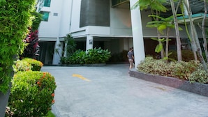 A modern building with a multi-story structure, a covered entrance, and surrounding greenery. - Swiss Garden Residence Kuala Lumpur (Kuala Lumpur)