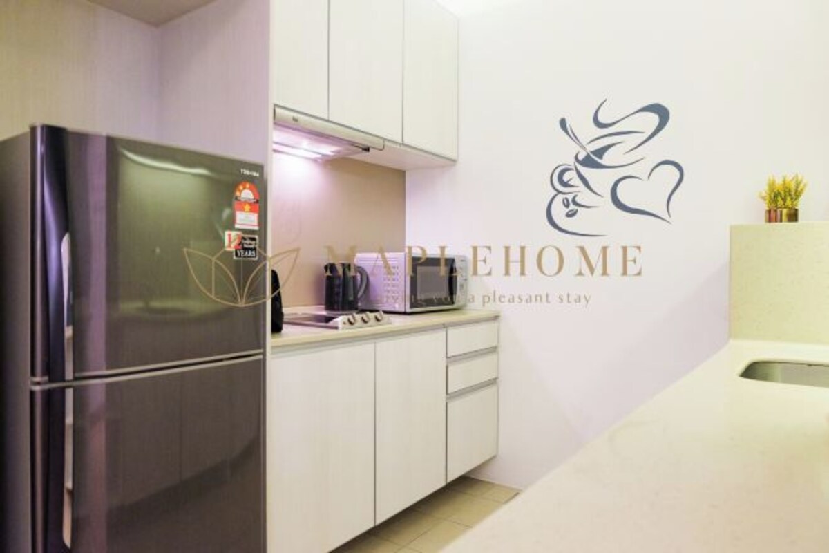 A modern kitchen with a stainless steel refrigerator, a microwave, and a sink.