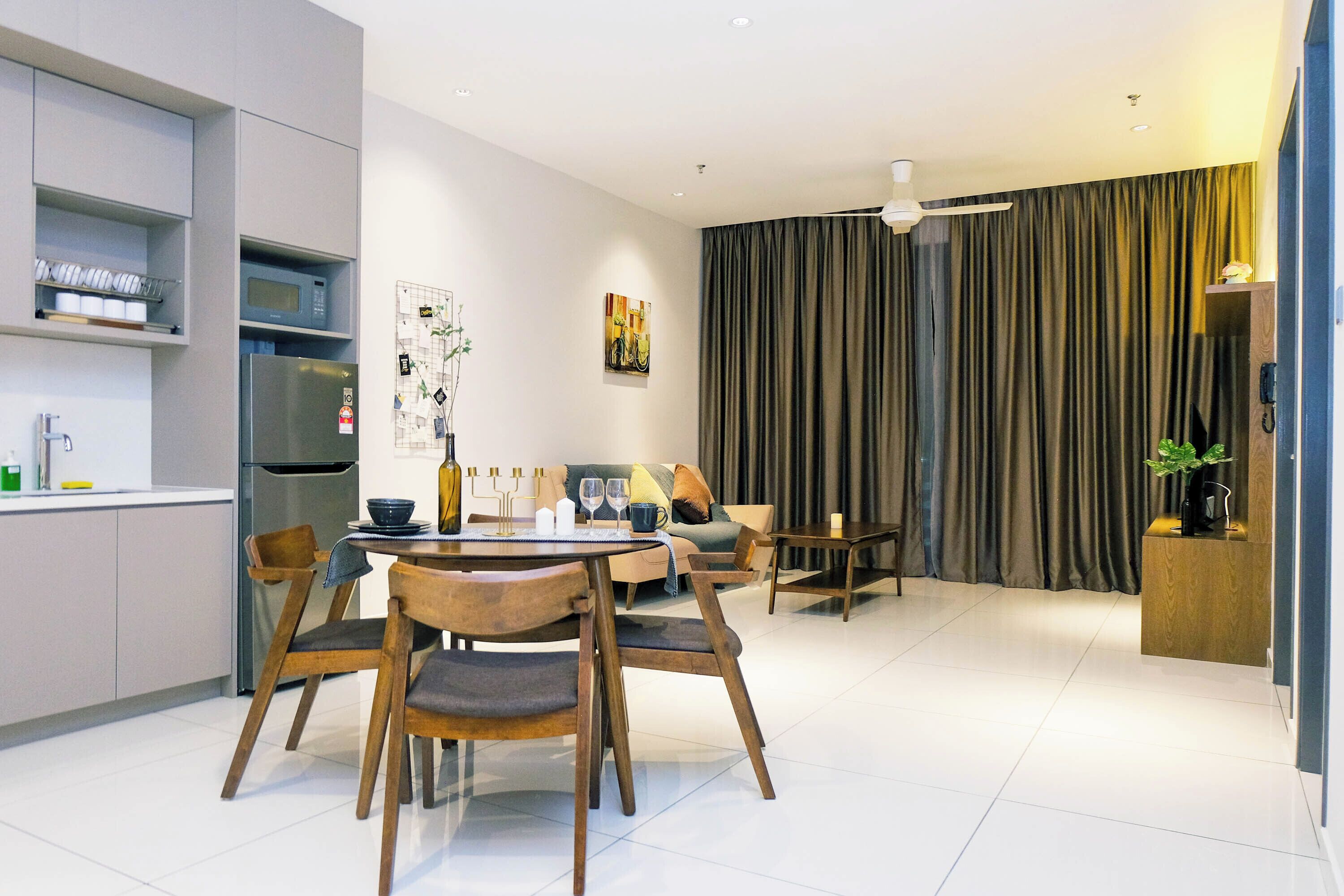 A modern living space with a dining area, kitchen, and seating area.