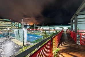 A rooftop terrace with climbing walls, a pool, and a view of a cityscape at night. - Geo38 Premier Suites Genting Highlands (Genting Highlands)