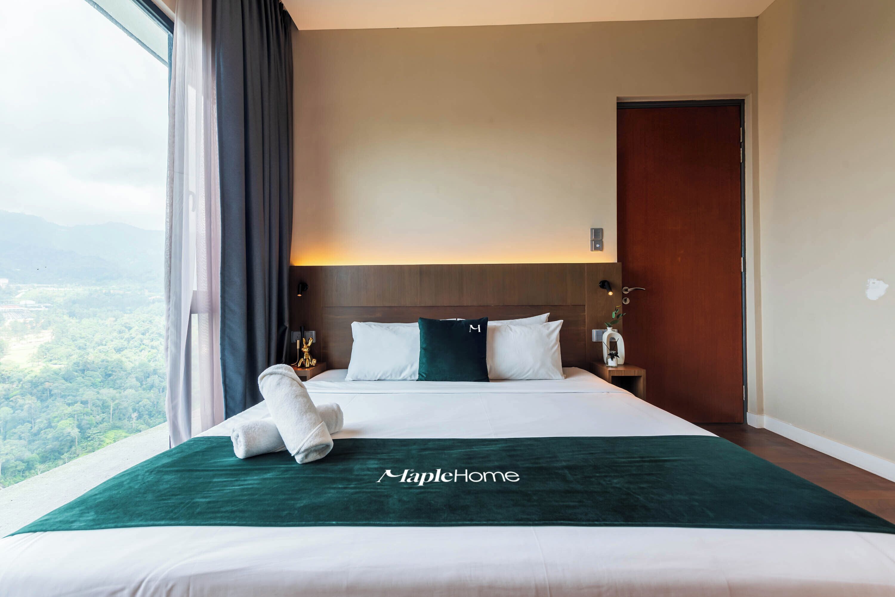 A hotel room with a large bed, a view of the outdoors, and a wooden headboard.