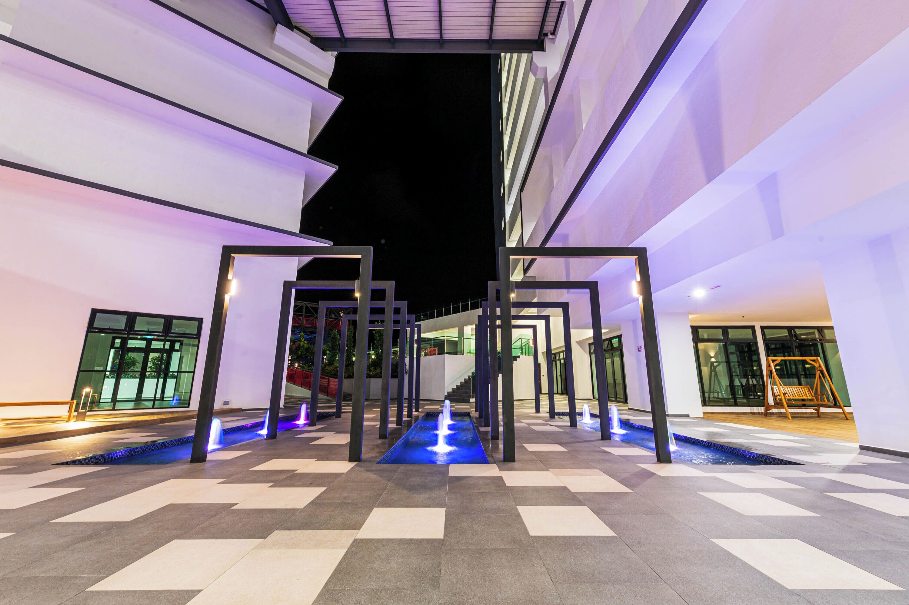 A modern outdoor area with a geometric pool design, a staircase, and a swing set.